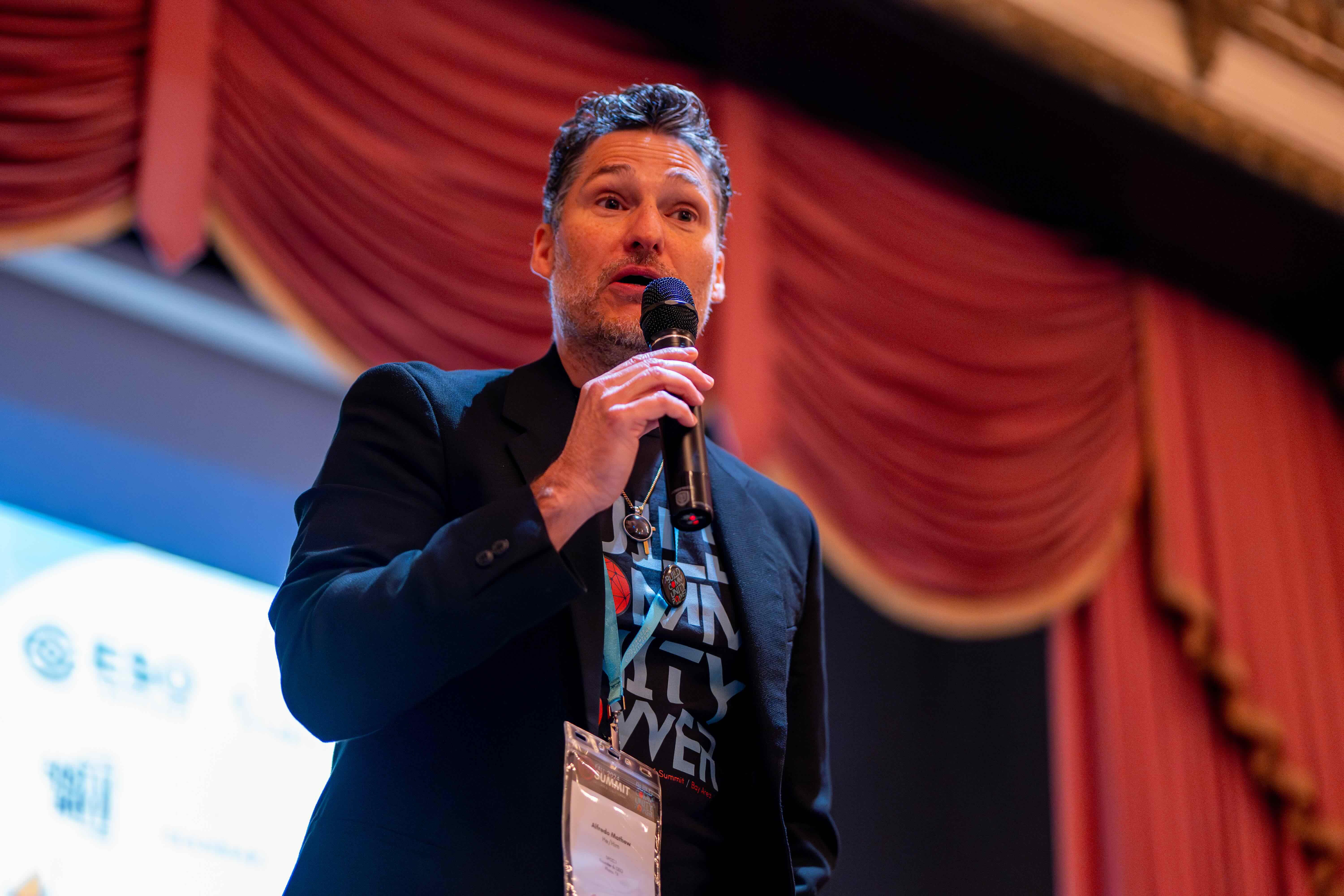 Alfredo Mathew III speaking on stage